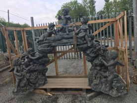 Stone garden archway featuring craved figures