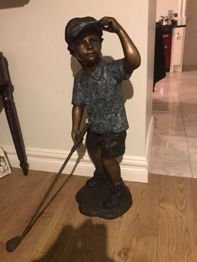 Brass statue of a golfer