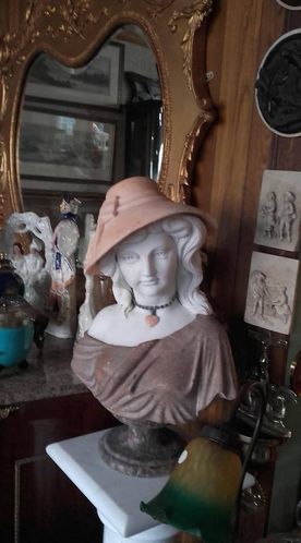 Ornamental bust of a woman wearing a hat 